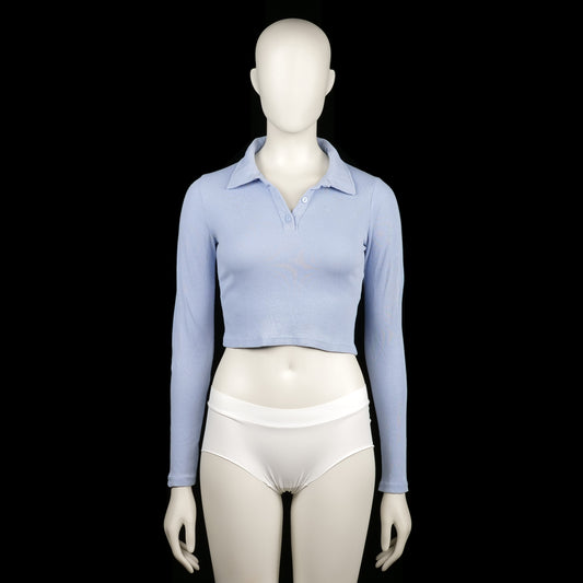 Fb Sister - Polo - Light Blue - Size S - Light blue cropped polo top with ribbed texture, featuring a polo collar and partial front button placket. The sleeves are long with plain cuffs and a straight hem.